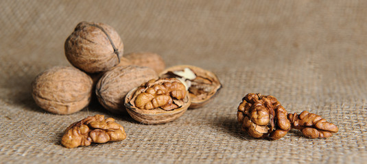 Walnut kernels and whole walnuts on burlap