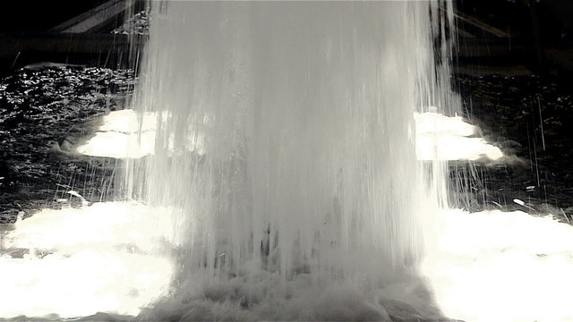 Water falling down a fountain bursting massive amounts of water
