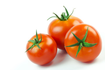 Tomatoes. Whole and a half isolated on white