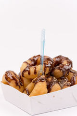 Close view of donuts with chocolate cream over white background
