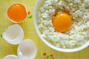 cottage cheese and eggs on a yellow tablecloth