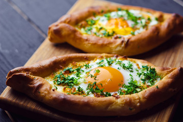 Beautiful open pies with egg and onions on wooden background