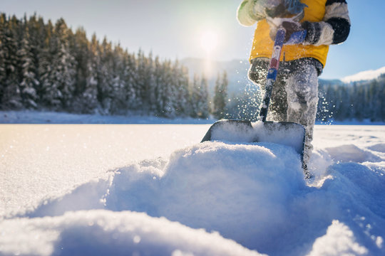 Close-up Of A Boy Shoveling Snow