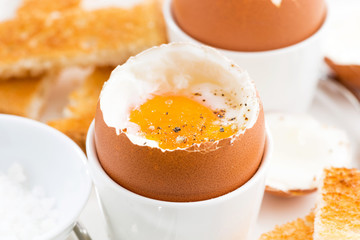 soft boiled eggs and crispy toast for breakfast, closeup
