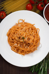 Spaghetti with tomato sauce and ingredients, top view