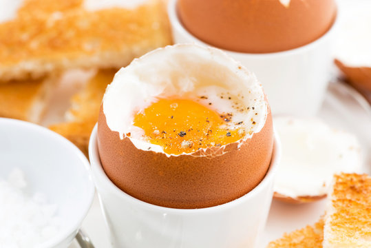 soft boiled eggs and crispy toast for breakfast, closeup