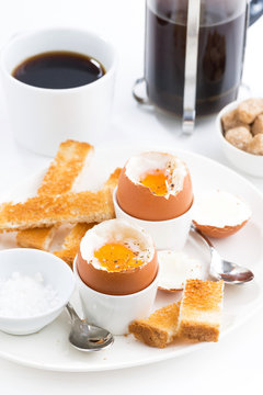 soft boiled eggs, crispy toast and coffee for breakfast