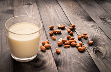 Glass of milk on wooden background