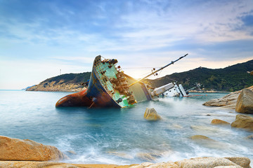 shipwreck or wrecked cargo ship abandoned - 105341716