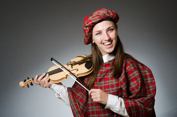 Woman in scottish clothing in musical concept