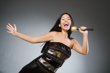 Young woman singing in karaoke club