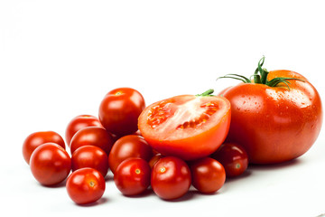 Tomatoes. Whole and a half isolated on white