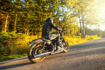 Motorcyclist riding  chopper on a road