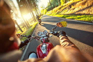 Motorcyclist riding motorbike in sunny morning - obrazy, fototapety, plakaty