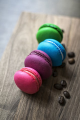 Colorful macaroons on wooden background.