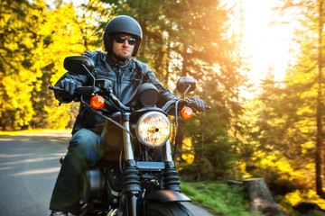 Obraz premium Motorcyclist riding chopper on a road