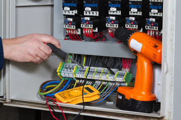 electrician at work with an electric panel