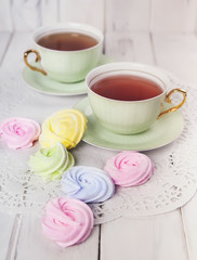Small spiral meringues  on the table. Toned image. Pastel colored.