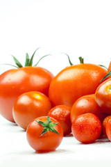 Tomatoes. Whole and a half isolated on white
