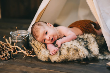 baby boy, photo studio on a wooden background