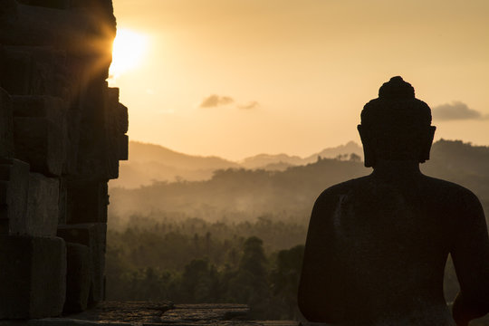 Rear view of a buddha statue on Borobudur temple, Central Java, Indonesia