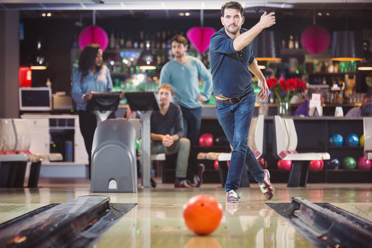 Group of friends playing in bowling alley