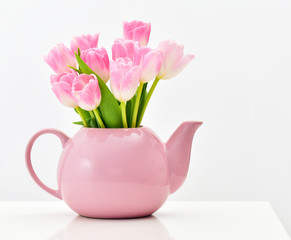 Bright spring bouquet in a porcelain teapot. Pink tulips.