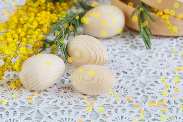 Obraz na płótnie Canvas Easter wooden eggs with a mimosa