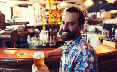 happy man drinking beer at bar or pub