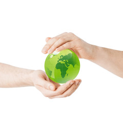 close up of hands holding green globe