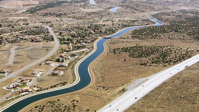 Aerial shot of aqueduct with freeway bridge