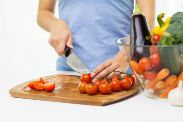 close up of woman chopping tomatoes with knife