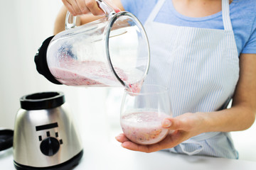 close up of woman with blender and shake at home