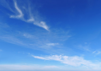 Clouds in a blue sky. Good weather. Clear blue sky with a few fluffy cumulus clouds. 