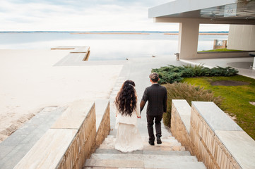 lovers is running with hold hands on city park