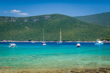 Obraz premium Recreational boats and yachts at anchor in a beautiful calm bay with dreamy water
