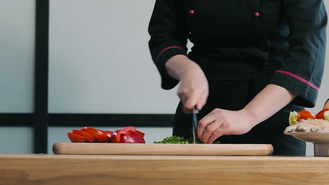 Chef chopped green onions on a cutting board