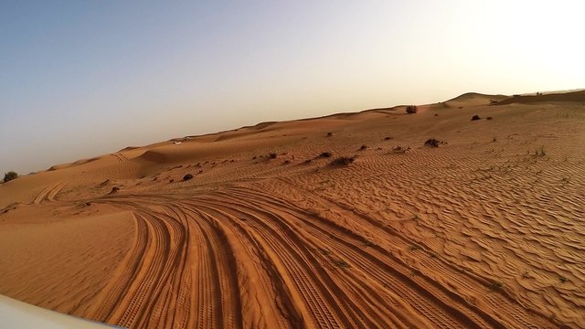 4x4 off road land vehicle taking tourists on desert dune bashing safari, Middle East