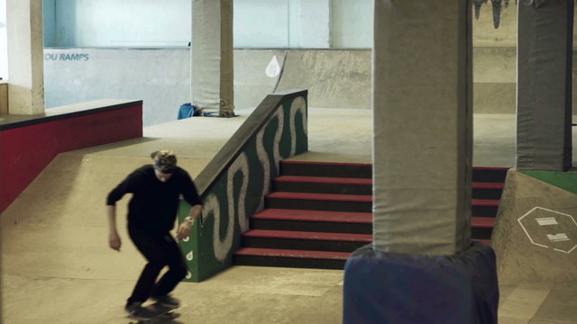Skateboarder doing trick on the rails in the skatepark