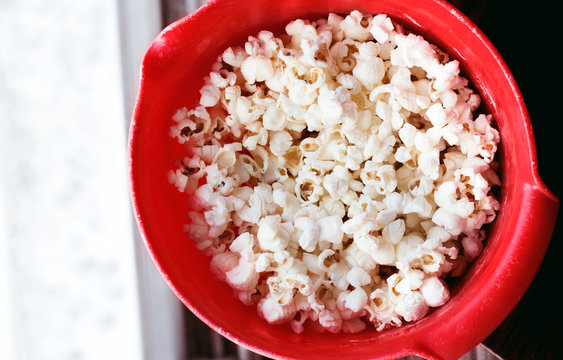 Closeup of homemade popcorn in a red bowl