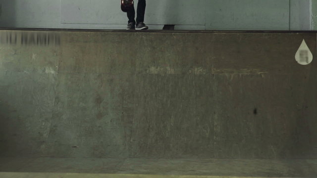 A guy on a skateboard moves down from the ramp
