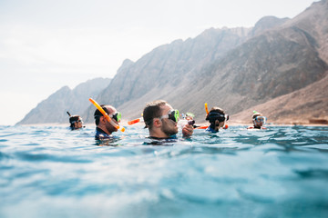 Group of friends snorkeling in a sea - obrazy, fototapety, plakaty