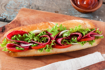 sandwich baguette tomato salami tomato sauce and herbs