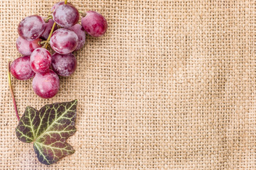 Red grapes on a wooden background
