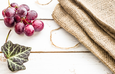 Red grapes on a wooden background