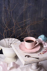 Coffee in pink vintage cup on antique table. Provence style.