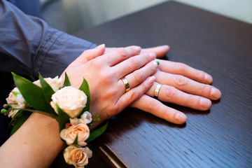 Hands with engagement gold rings