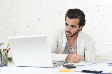 student preparing university project or hipster style freelancer businessman working with laptop