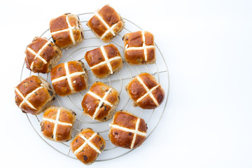 Freshly baked, Easter hot cross buns on an isolated white background.