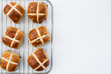 Freshly baked, Easter hot cross buns on an isolated white background.